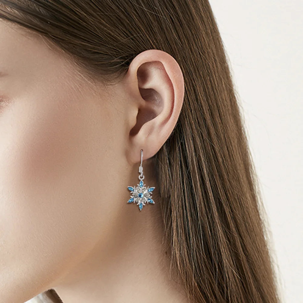 Festive women's silver snowflake jewelry, perfect dangle earrings for Christmas holiday.