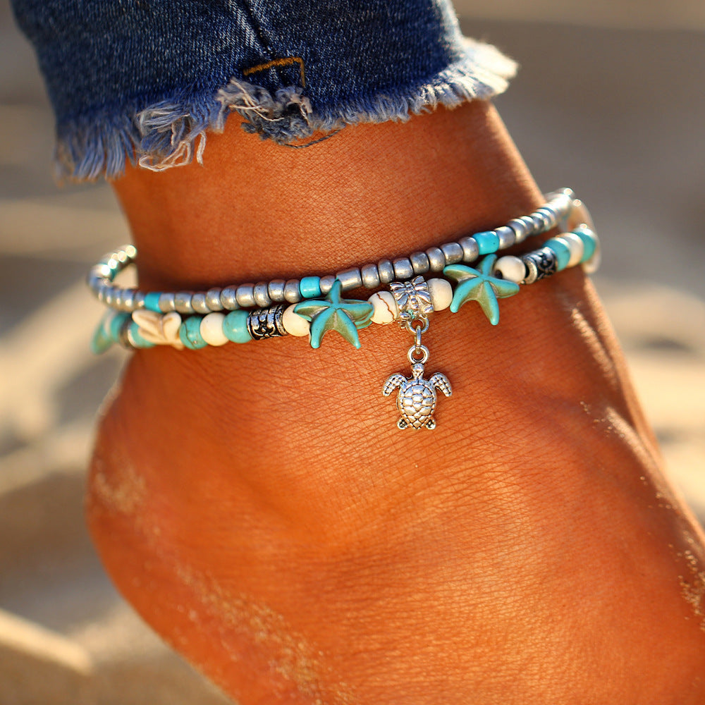 Women's silver turtle anklet with natural seashells. Perfect beach jewelry for summer fashion.