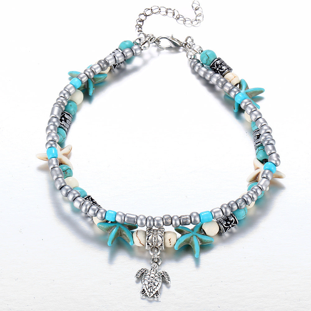 Adjustable silver turtle charm anklet with natural sea shells, ocean-inspired for women.