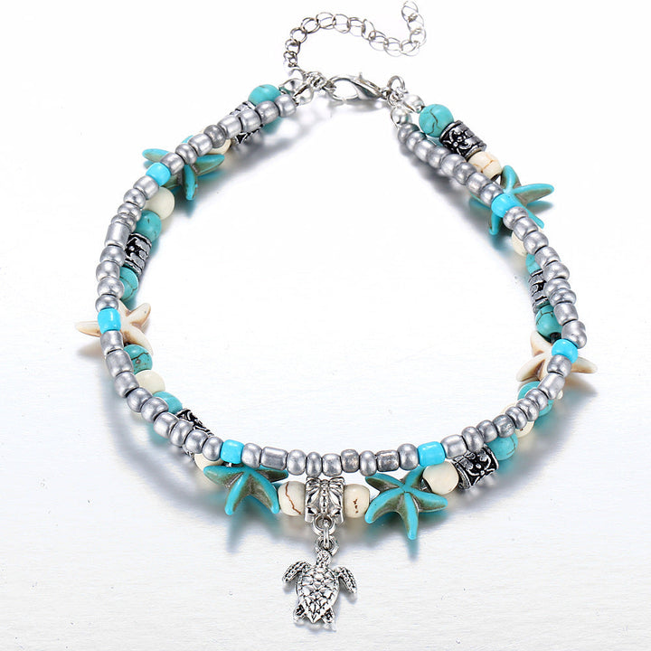 Adjustable silver turtle charm anklet with natural sea shells, ocean-inspired for women.