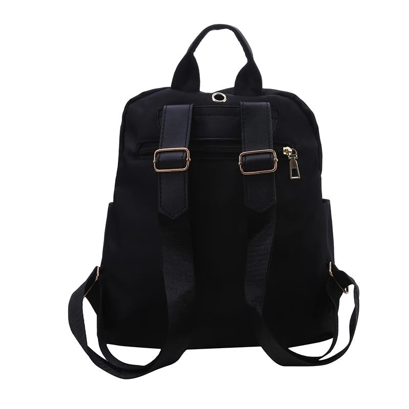 Close-up of women's black PU leather travel backpack, highlighting texture and design.