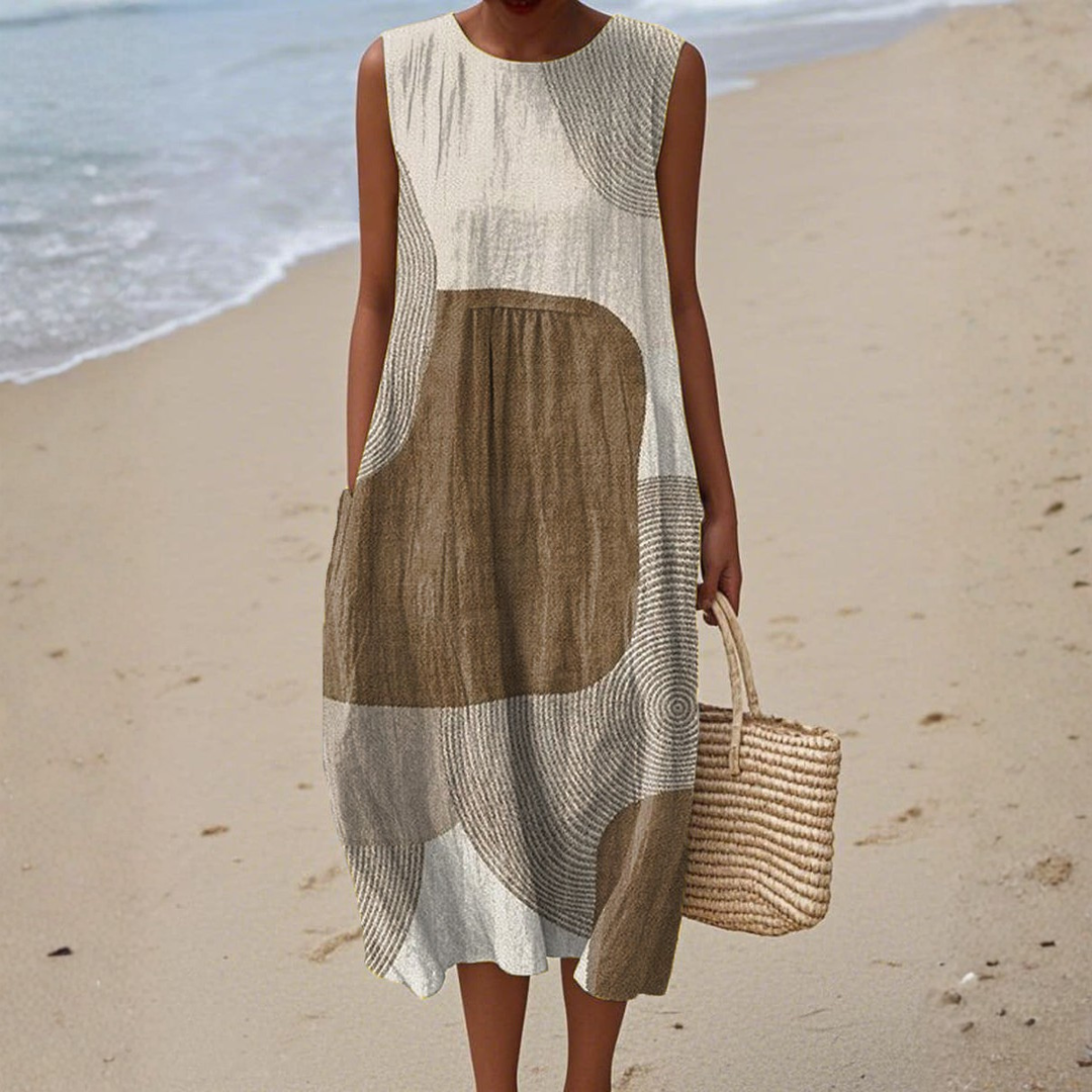 Flowy women's summer midi dress featuring a vibrant abstract print. Ideal comfortable casual everyday wear.