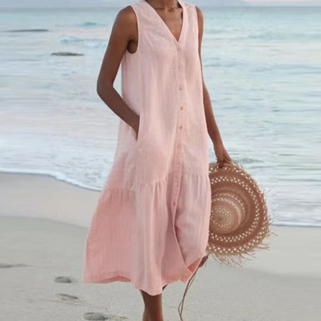 Elegant women's sleeveless midi dress with button detailing, great for a relaxed beach or vacation look.