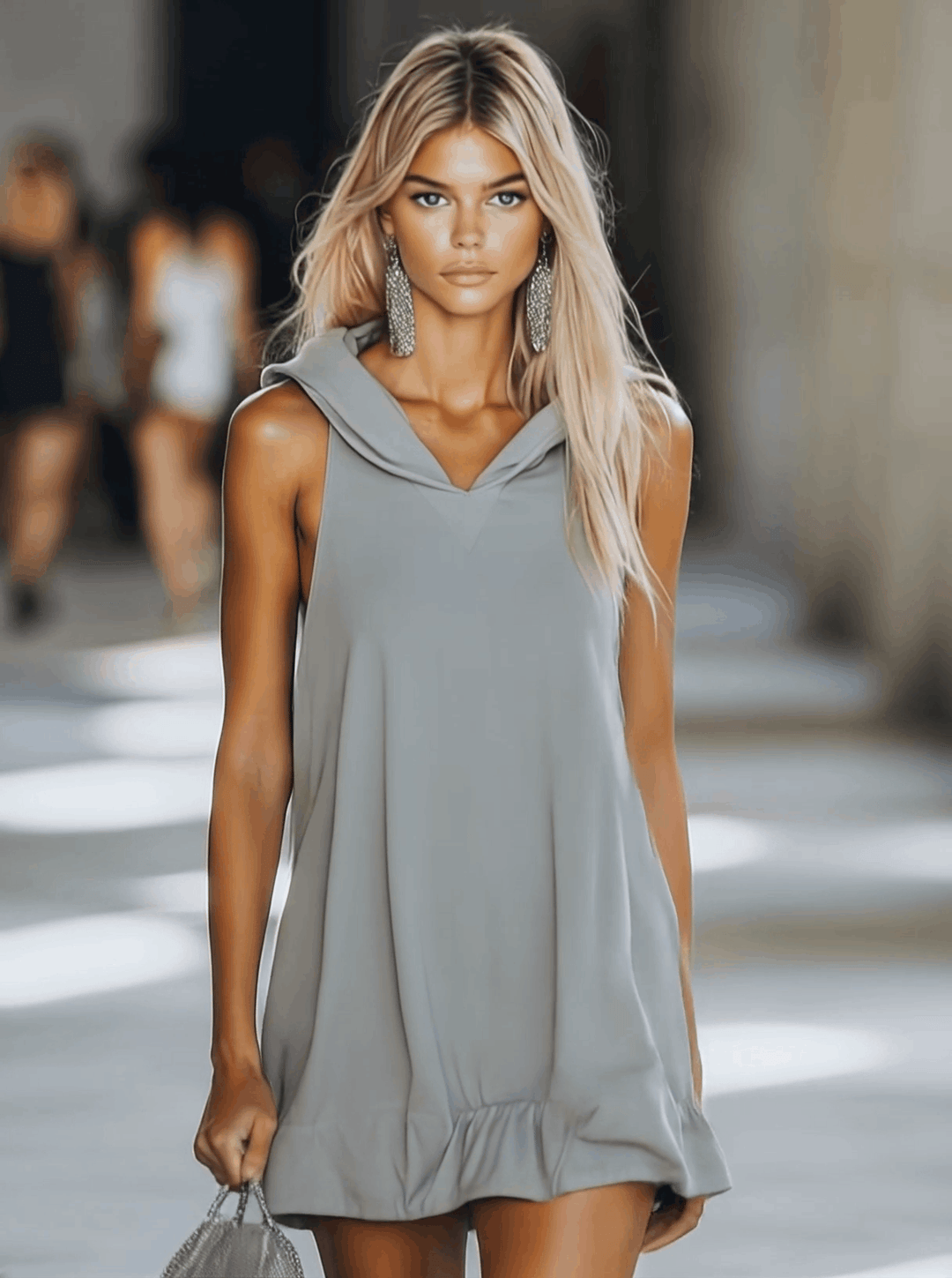 Comfortable women's sleeveless hooded mini swing dress with playful ruffle hem, ideal for versatile summer looks.