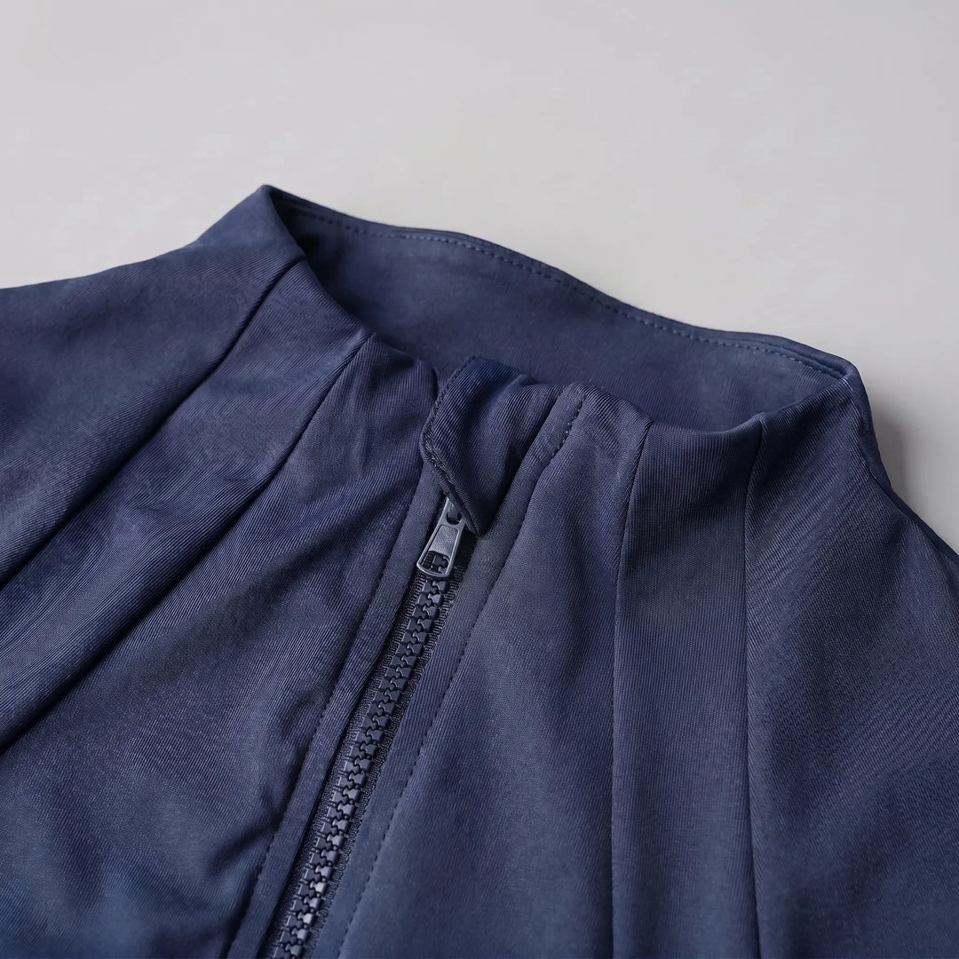 Woman running outdoors wearing a sleek slim-fit activewear jacket. Perfect for sports.