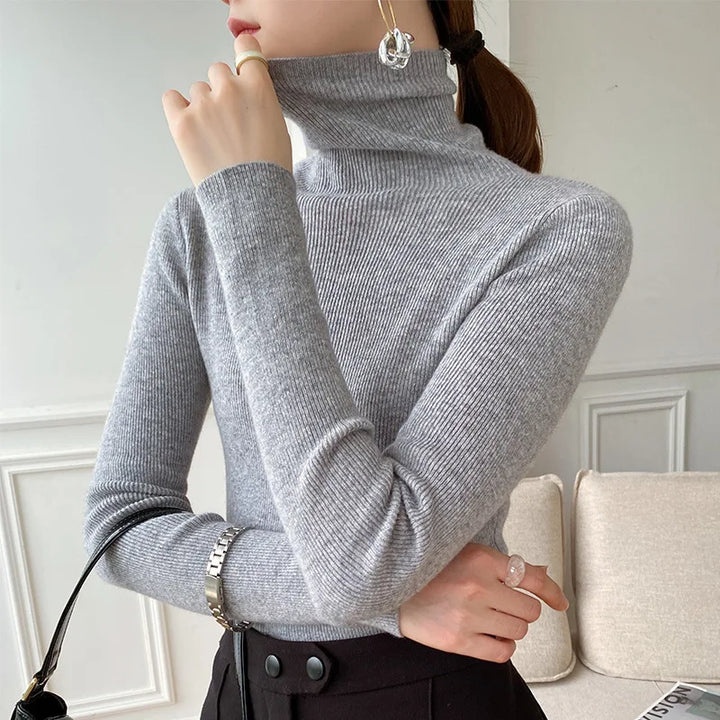 Women's elegant turtleneck sweater, a slim fit layering top for comfortable winter fashion.