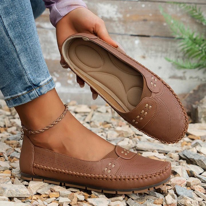 Stylish women's slip-on flats featuring a perforated design, offering everyday comfort for walking.