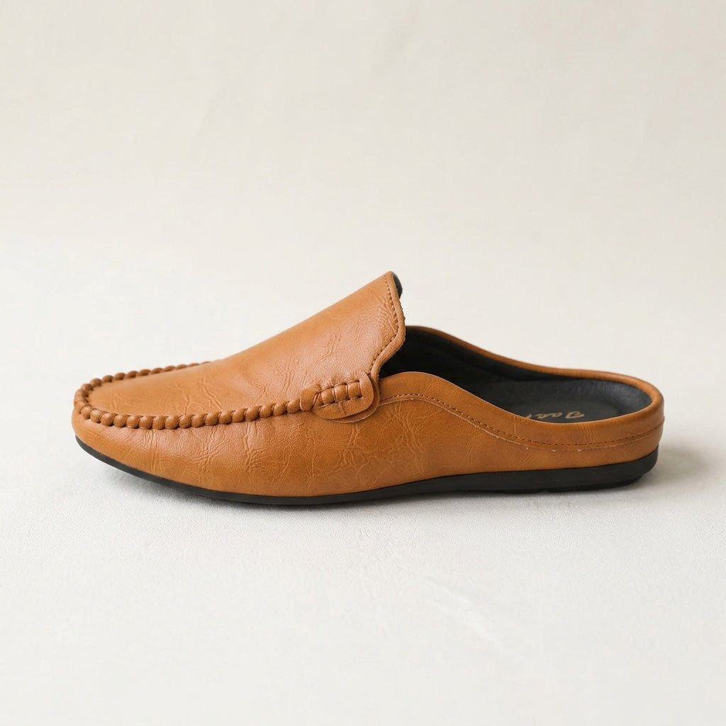 Brown slip-on mules for women, featuring hand-stitched detail. Comfortable flat casual footwear with open back.