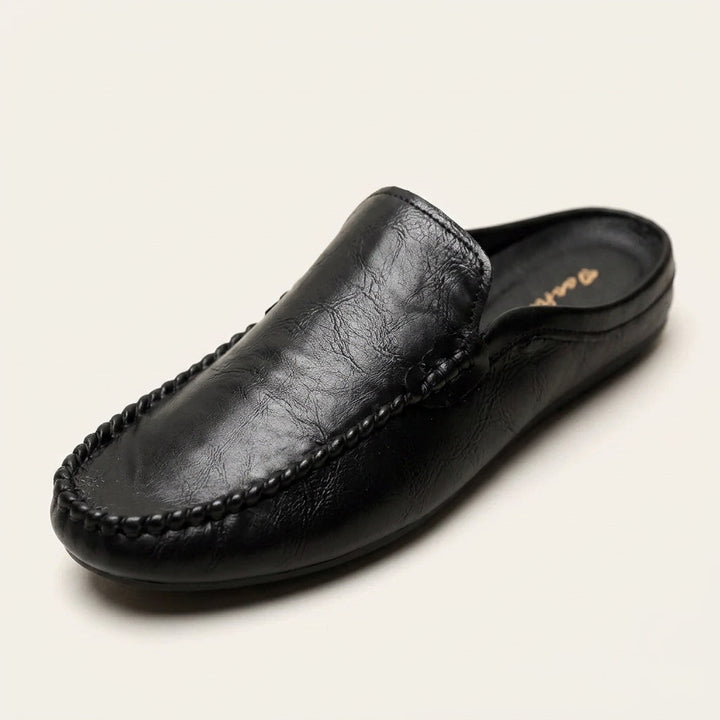 Hand-stitched detail on women's slip-on mules. Elegant open-back flat shoes, perfect for casual & comfortable wear.