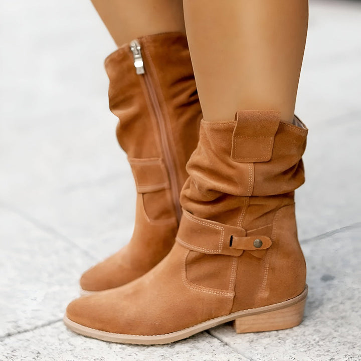 Stylish women's slouchy ankle boots with low heel and decorative buckle strap. Perfect for autumn footwear.