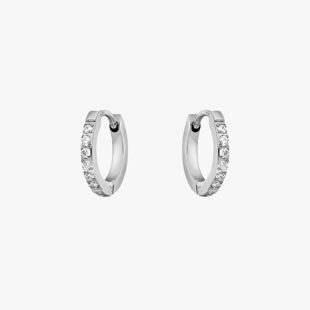 Women's gold tone small hoop earrings with shimmering zirconia stones. Elegant and versatile jewelry.