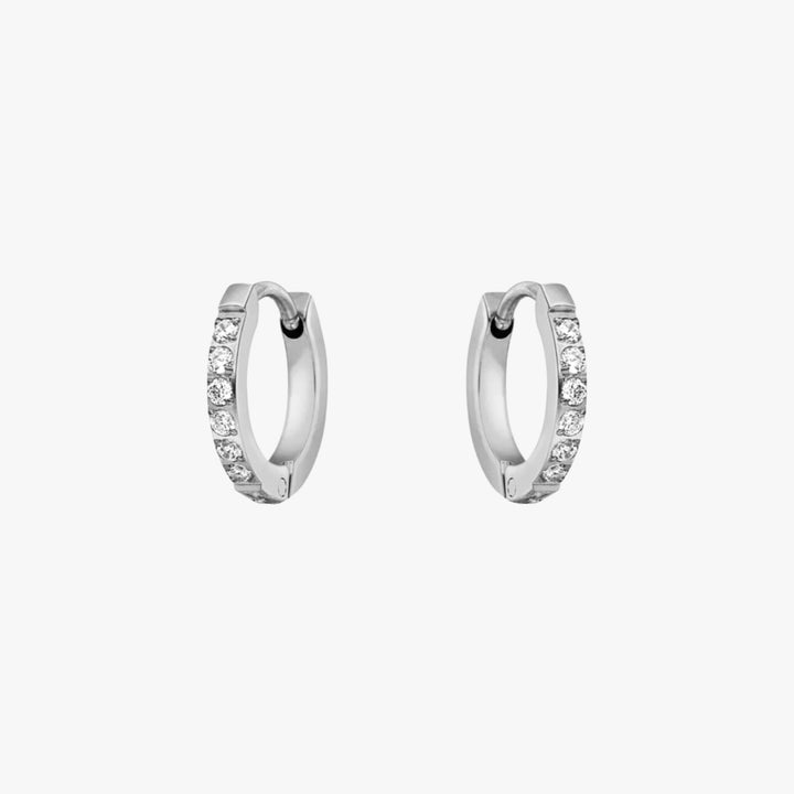 Women's gold tone small hoop earrings with shimmering zirconia stones. Elegant and versatile jewelry.