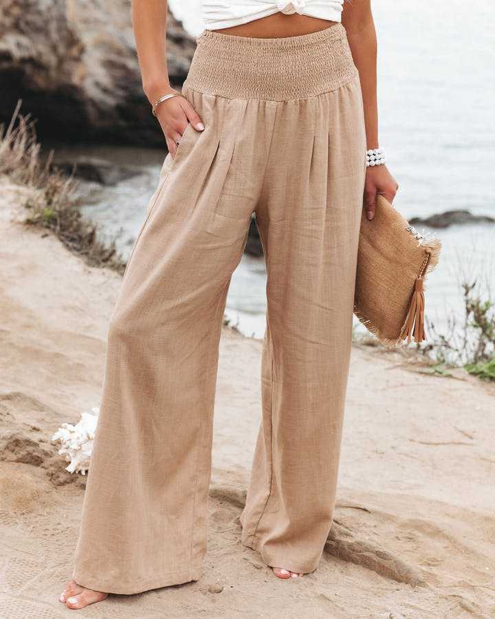 Women's smocked high waist wide leg pants, ideal for casual comfort & everyday fashion. Relaxed summer style.