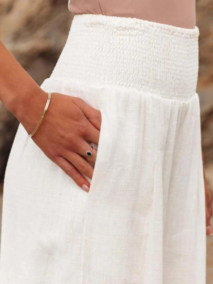 Relaxed fit women's smocked high waist wide leg pants in a soft fabric, perfect for summer casual wear & travel.