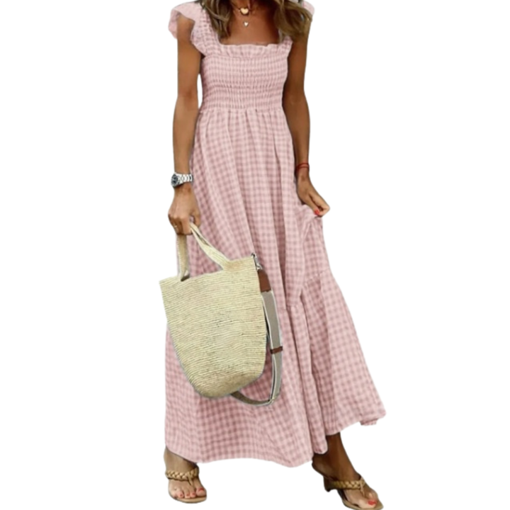 Women's smocked tiered maxi dress. Sleeveless, flowy, and long for elegant casual spring and summer wear.
