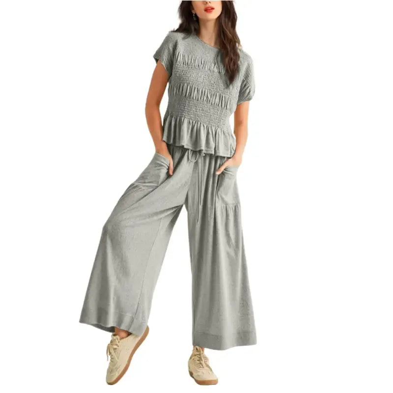 Stylish women's smocked top and wide leg pants lounge set. Comfortable and elegant two-piece fashion.