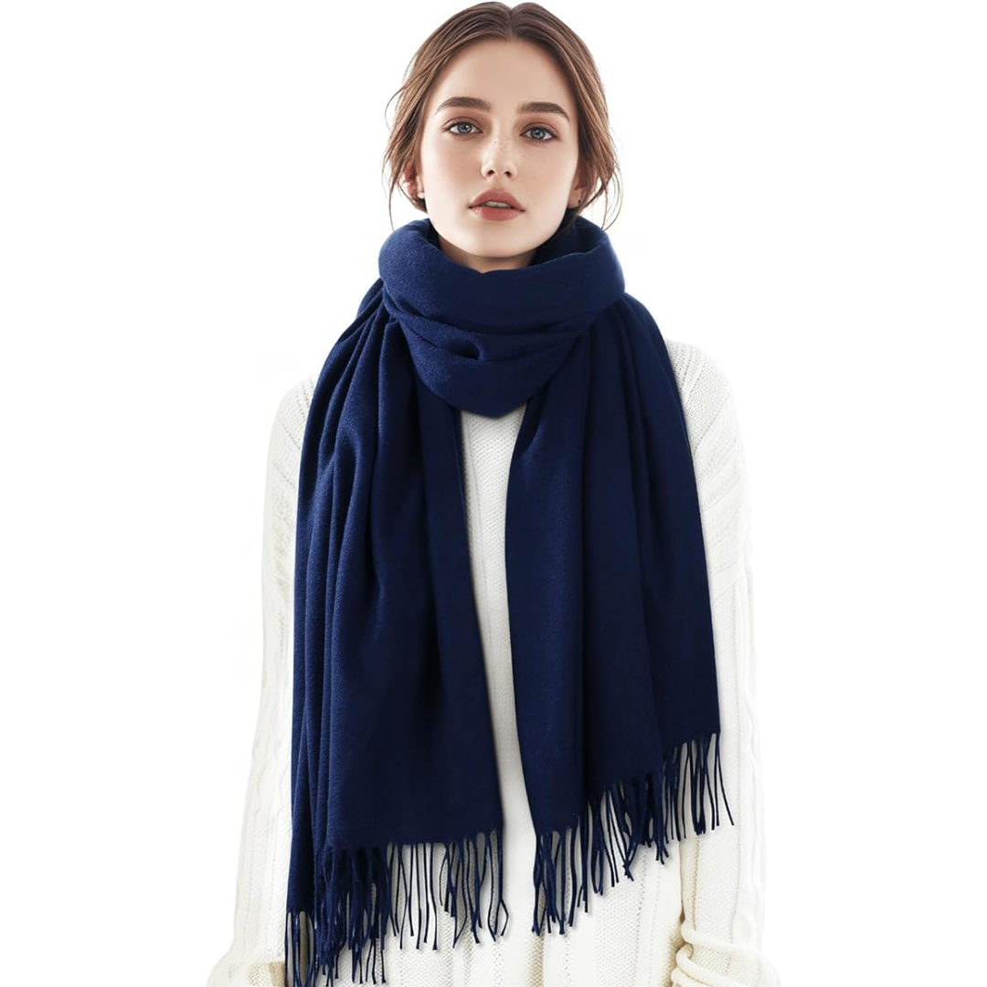 Woman wearing a draped cashmere blend plaid scarf, grey and white pattern, elegant winter fashion accessory.