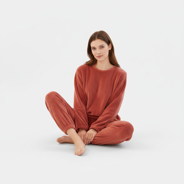 Model wearing a plush women's fleece pajama set, showcasing its comfort and warmth.