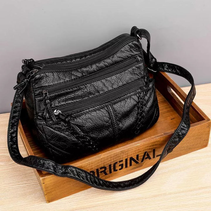 Elegant brown women's soft leather shoulder bag, versatile for daily use. Features a spacious main compartment.