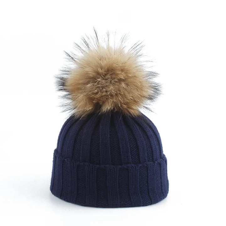 Cozy women's cream slouchy knit beanie with an oversized faux fur pom-pom, ideal for winter warmth