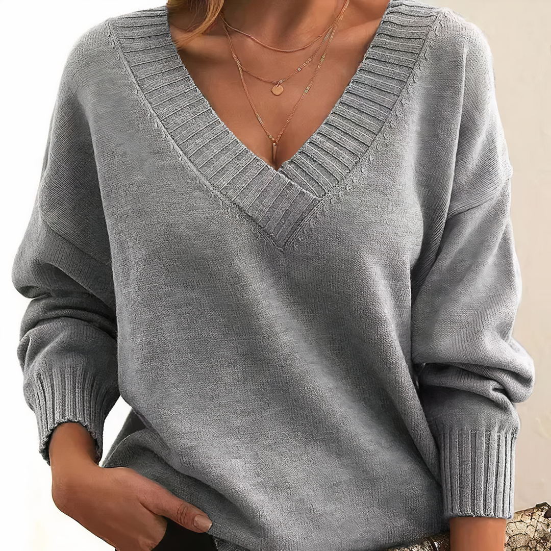 Warm women's V-neck long-sleeve sweater, a soft and comfortable knit top for cold weather.