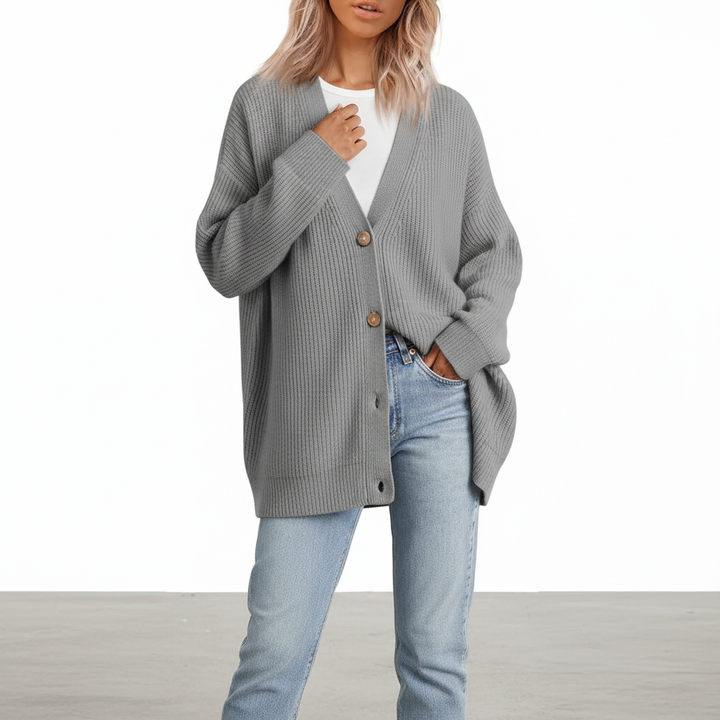 Side profile of a woman in a soft long sleeve V-neck cashmere sweater.