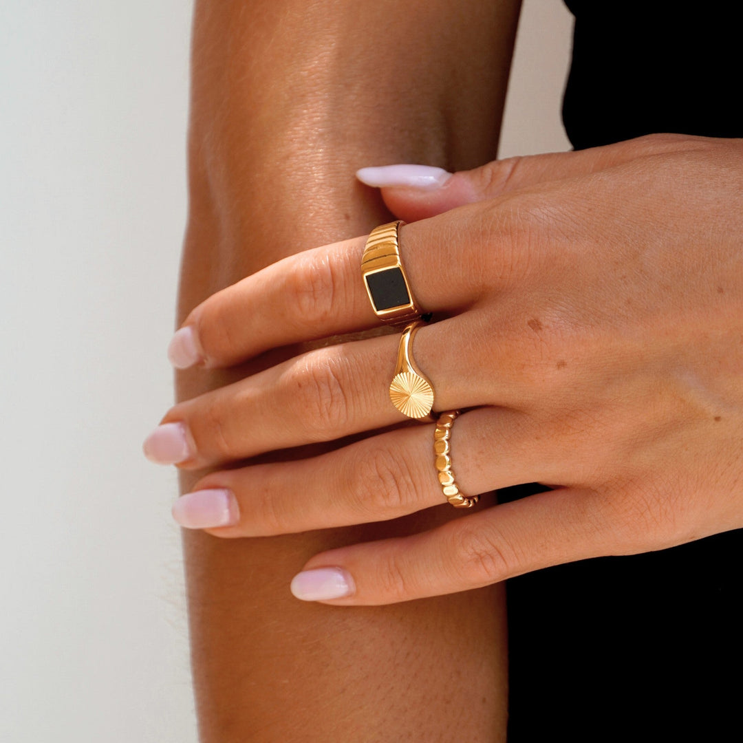Two-tone gold and silver women's Solara Sun Signet Ring, unique celestial sun design.