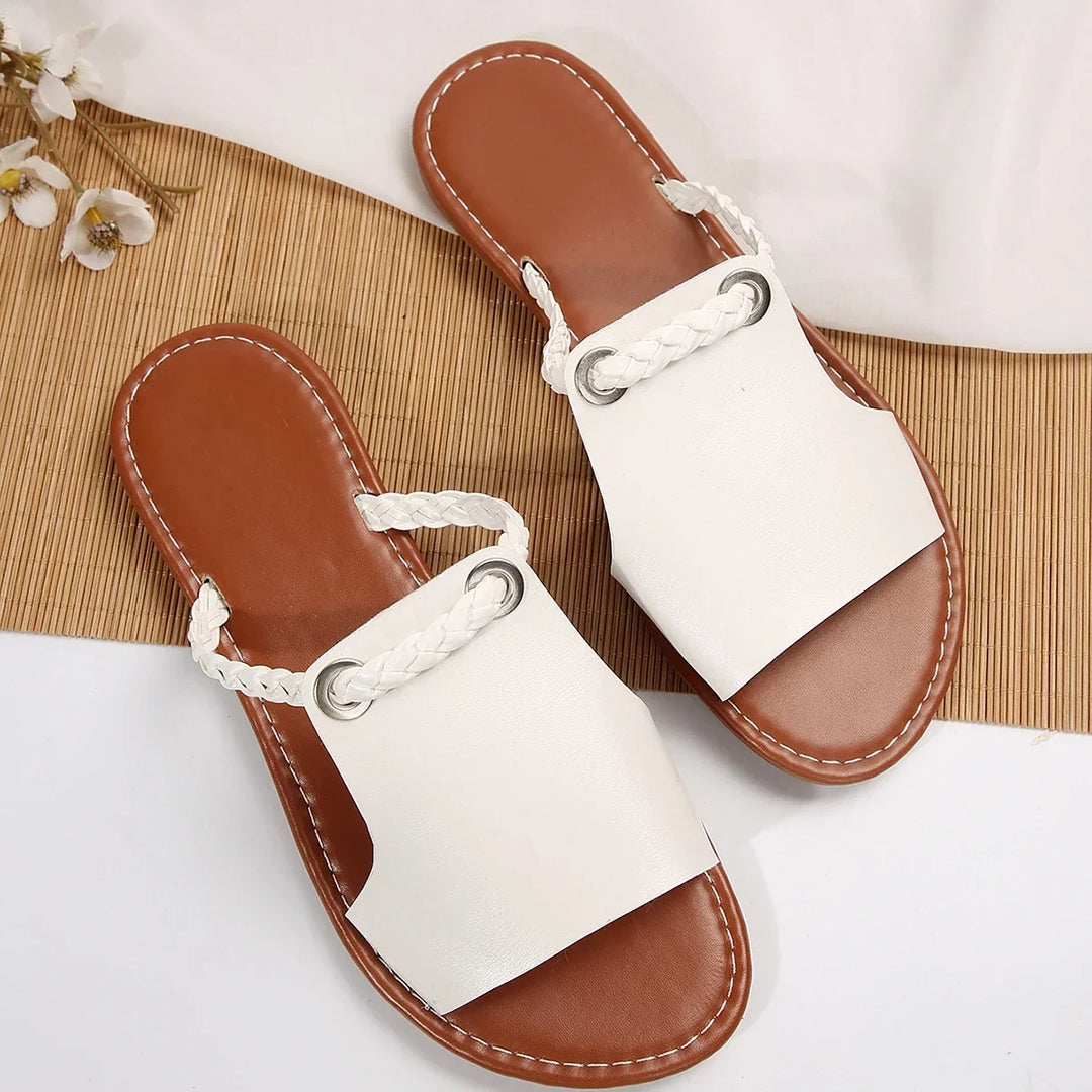 Textured braided straps on women's thong flat sandals, a chic summer essential.