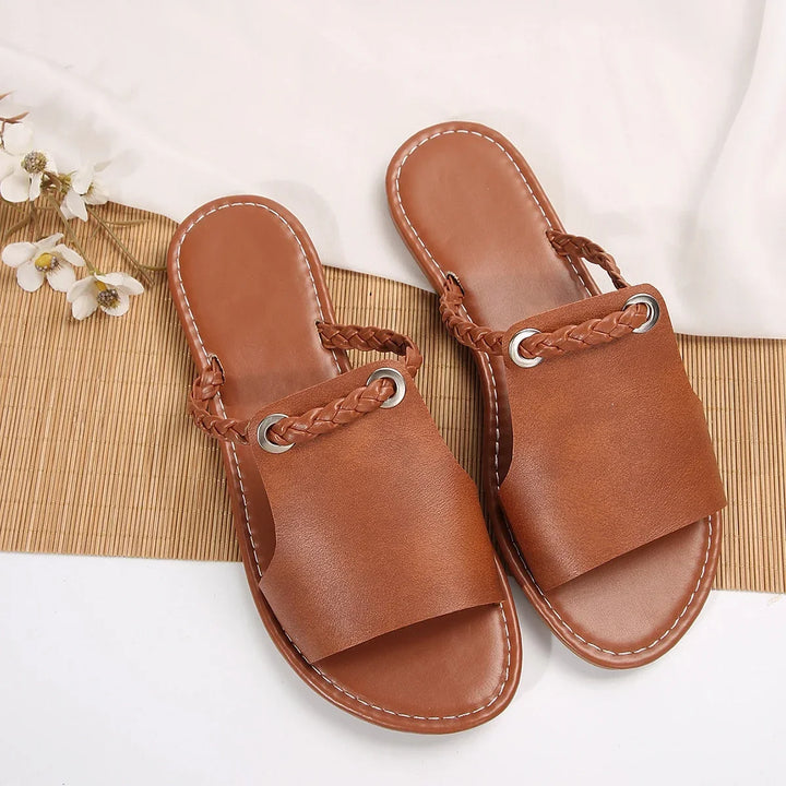 Women's flat thong sandals with braided detail, comfortable and casual slip-on design.