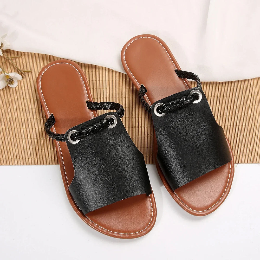 Close-up of the stylish braided strap on women's comfortable thong flat sandals.