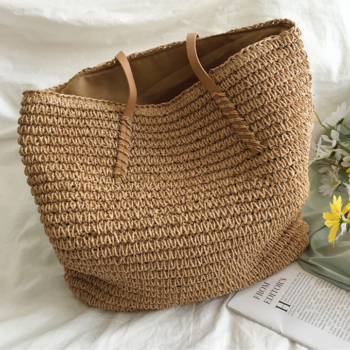 Women's spacious TerraWoven handbag with sturdy shoulder strap, elegant woven design.