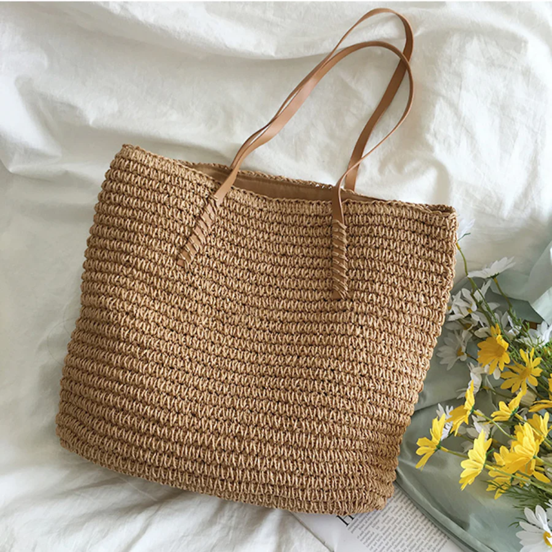 Close-up of TerraWoven women's handbag, showcasing rich woven texture & quality. A stylish brown accessory.