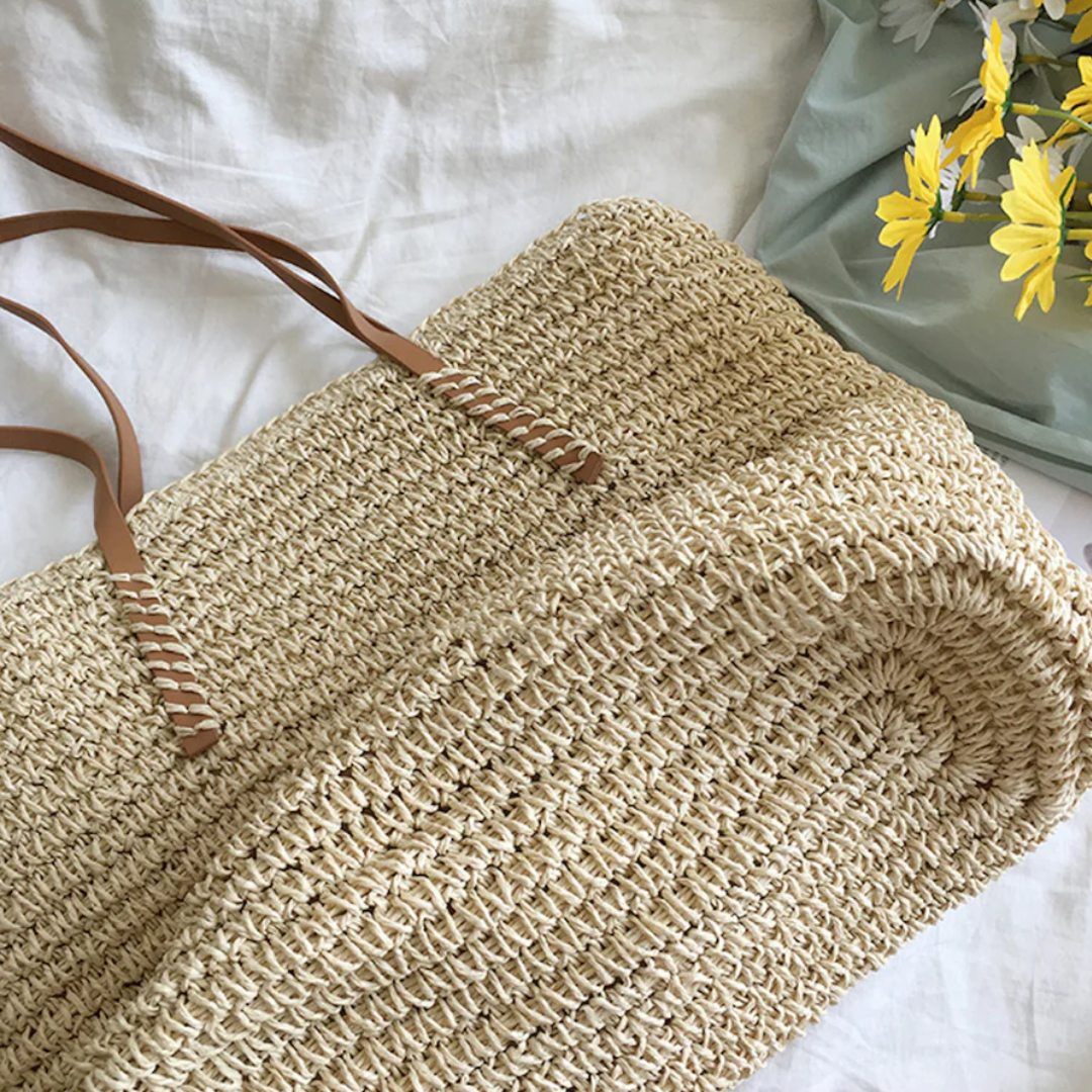 White TerraWoven women's shoulder bag, spacious and elegant fashion accessory. Features a sturdy strap & woven design.