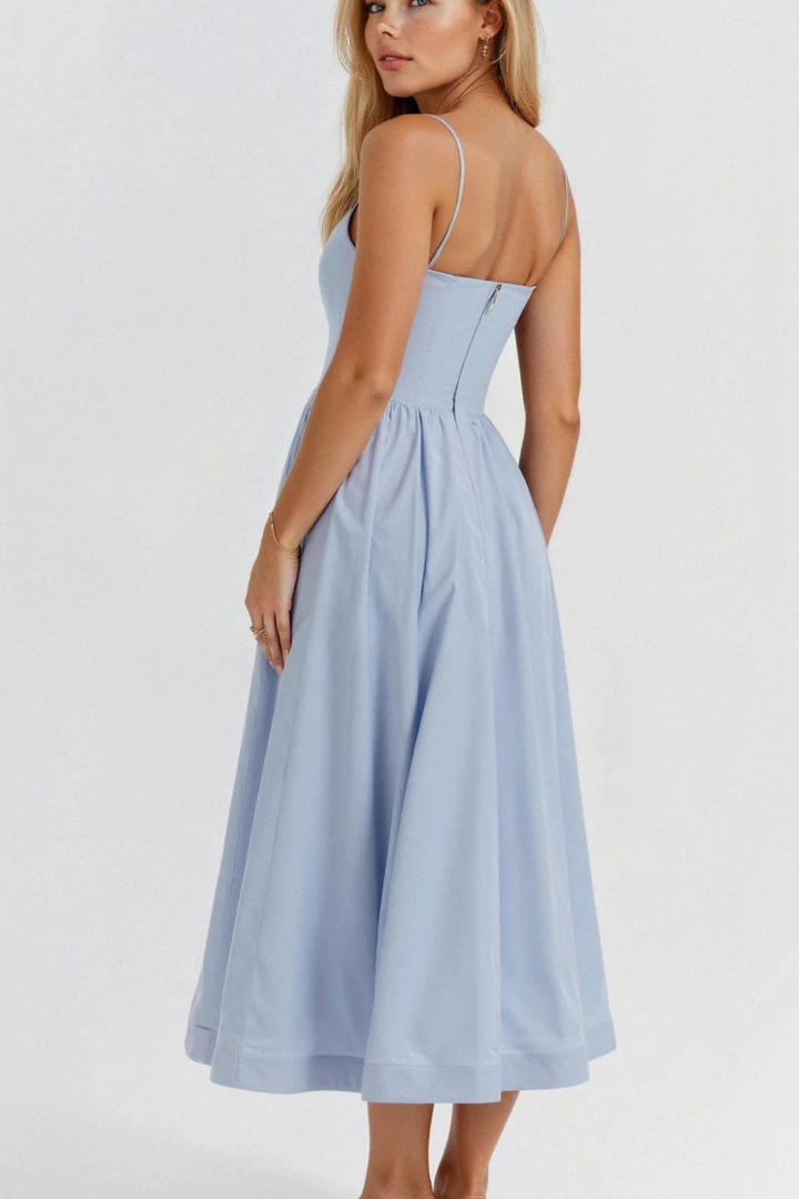 Stylish women's spaghetti strap midi dress, creating a breezy, effortless look for vacation wear.