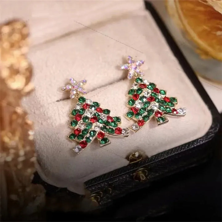 Elegant women's Christmas tree dangle earrings with glittering crystals, ideal for holiday style.