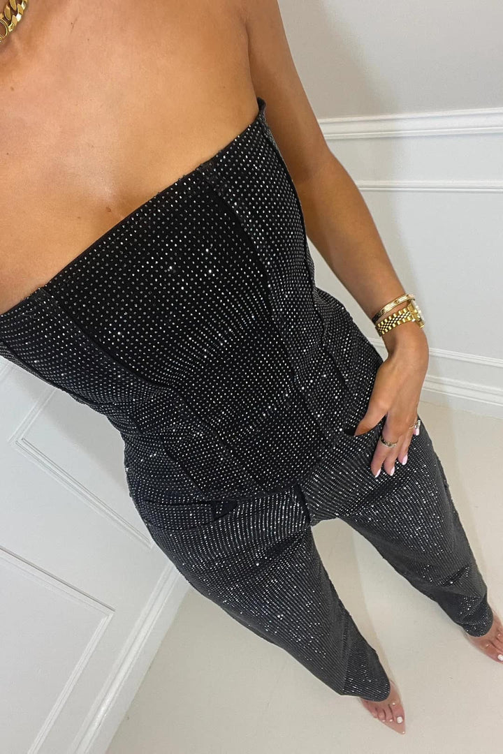 Close-up of sparkling glitter fabric on a women's crop top, part of a two-piece fashion set.
