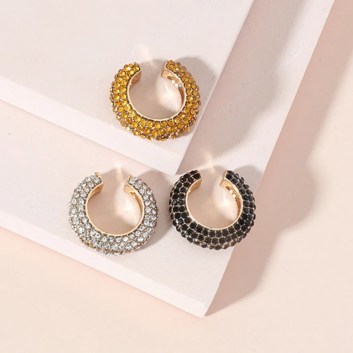 Gold women's ear cuff with sparkling pavé crystals, no piercing, chic jewelry.