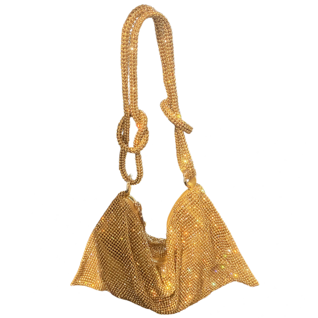 Close-up: Women's sparkling rhinestone clutch bag. Features metallic finish & elegant design.