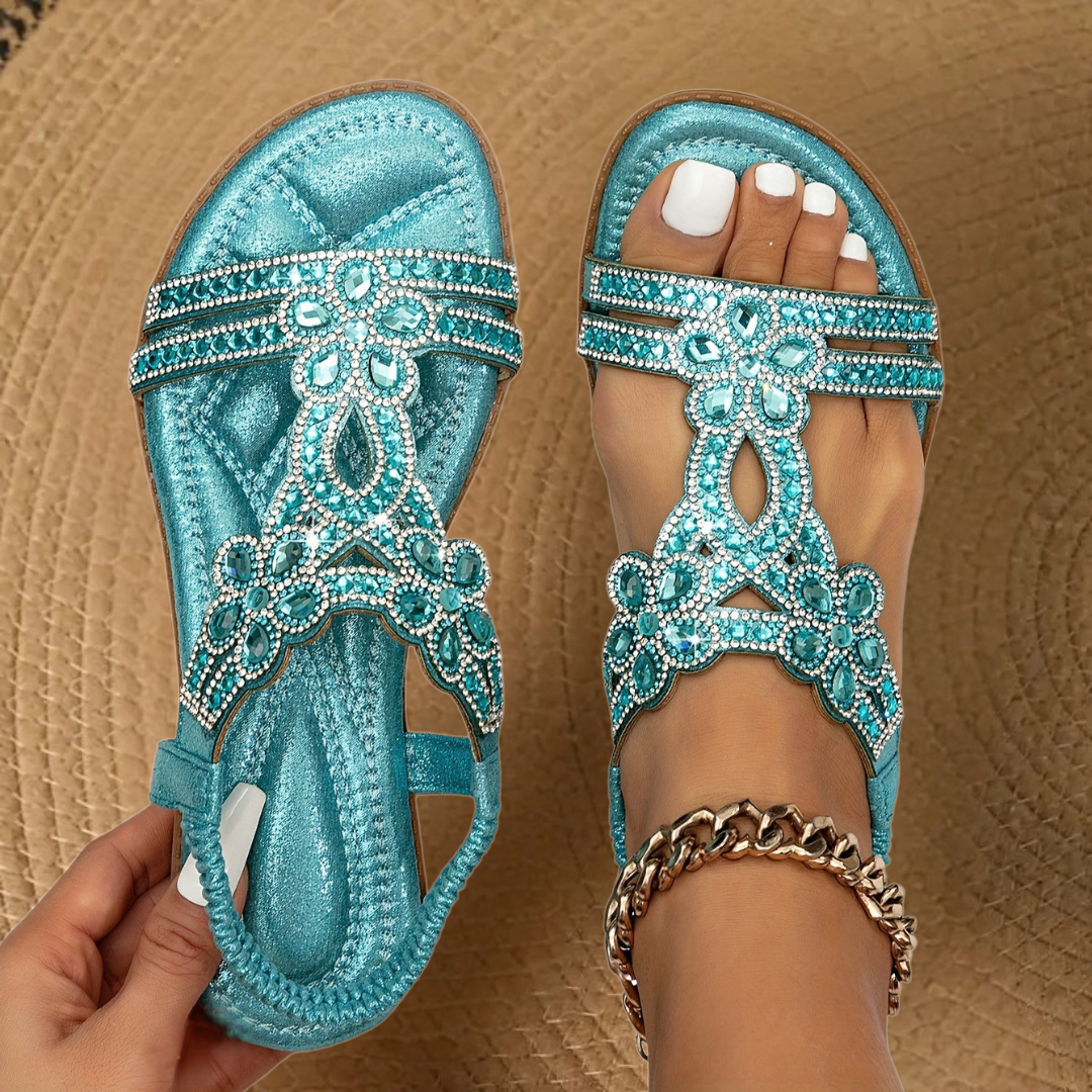 Women's sparkling rhinestone flat sandals for summer. Elegant open-toe beachwear with comfortable design.
