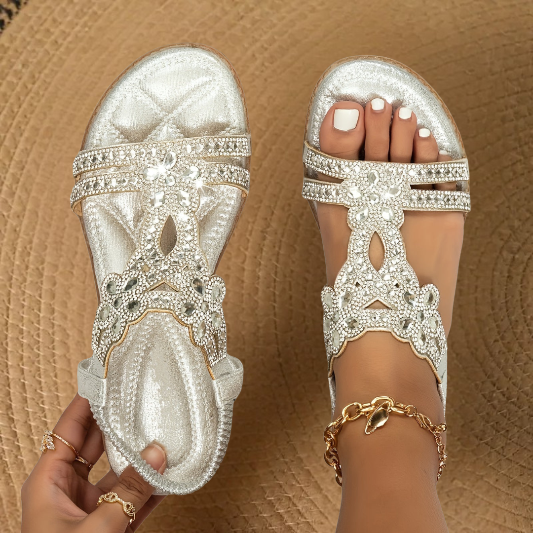 Fashionable women's rhinestone flat summer sandals on foot, offering comfortable and sparkling casual footwear.