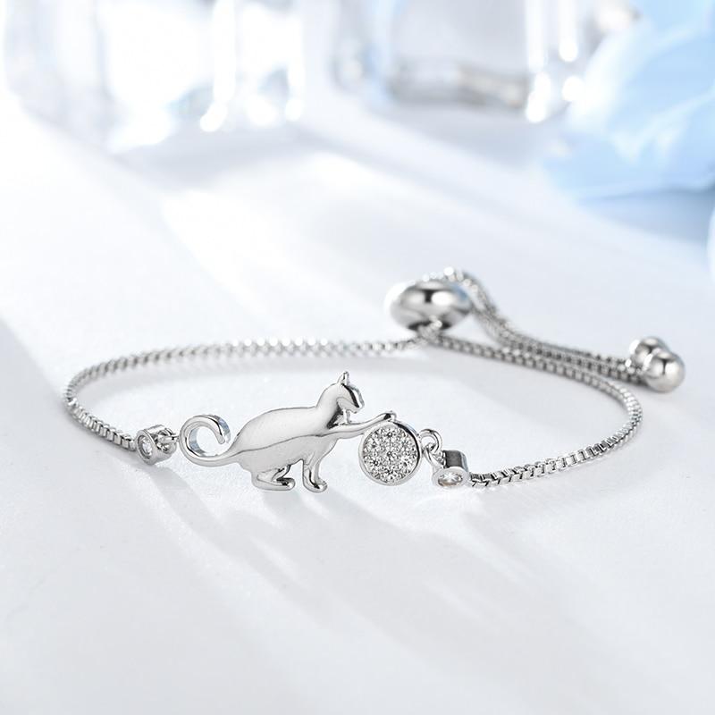 Women's sparkling silver-tone cat charm bracelet with cubic zirconia. Elegant adjustable jewelry, perfect gift for her.