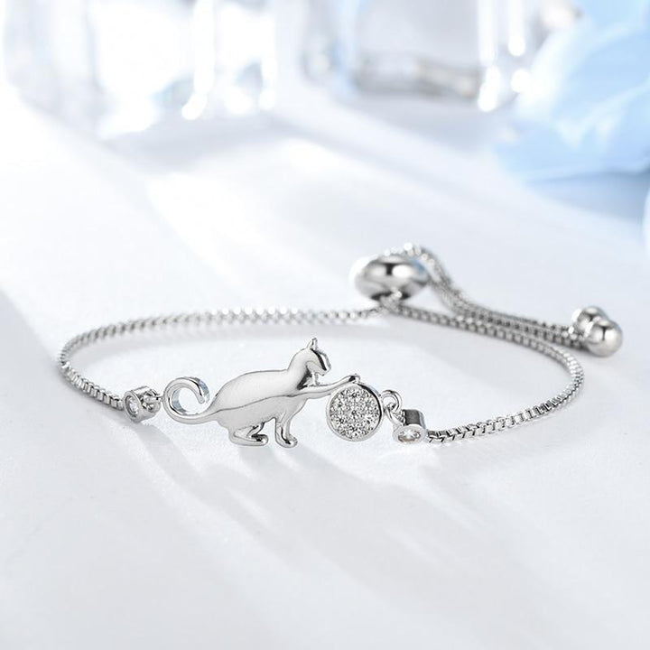 Women's sparkling silver-tone cat charm bracelet with cubic zirconia. Elegant adjustable jewelry, perfect gift for her.