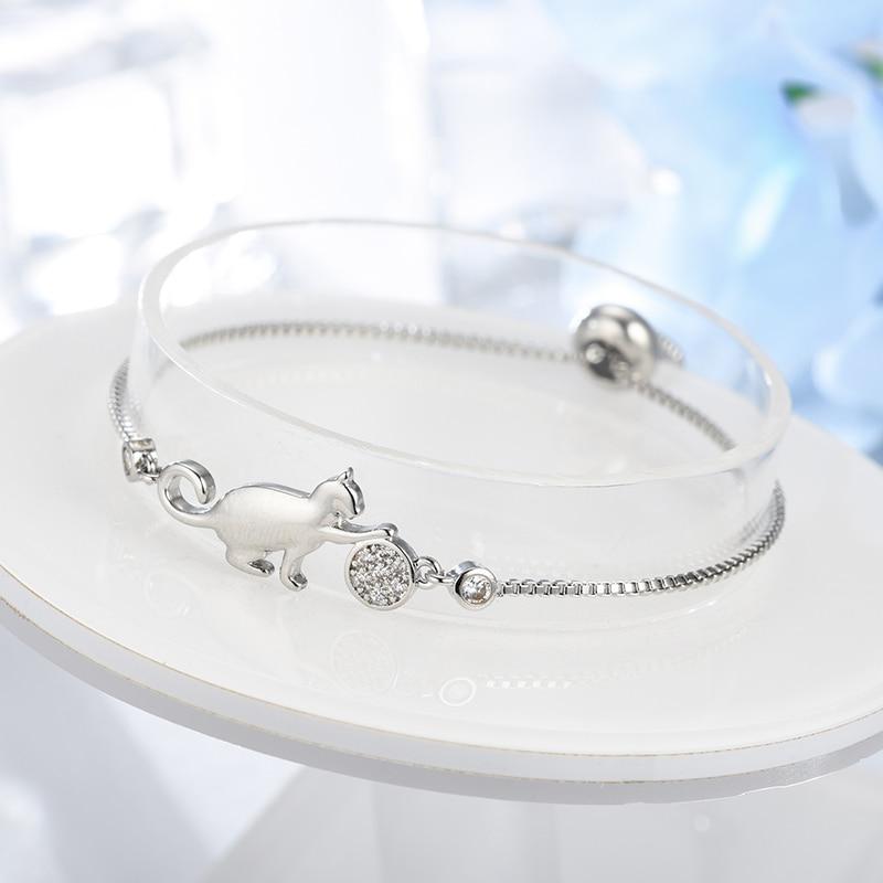 Elegant silver-tone cat charm bracelet for women, featuring sparkling cubic zirconia. Ideal jewelry for animal lovers.