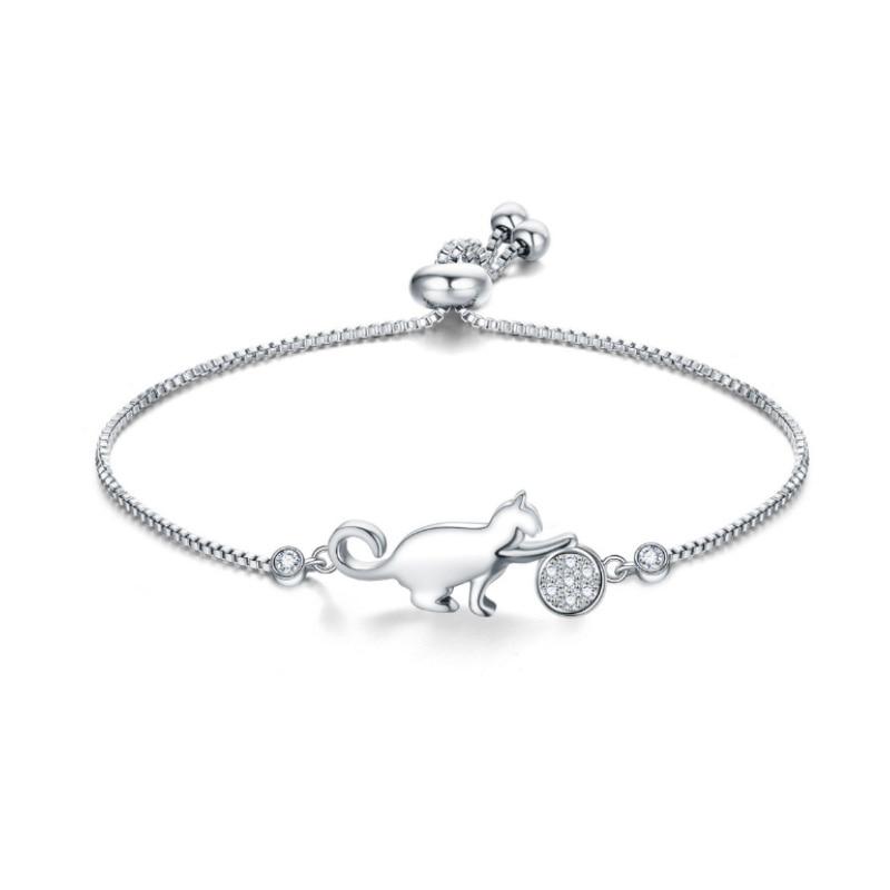 Close-up of elegant women's cat charm bracelet. Silver-tone with sparkling cubic zirconia, a chic accessory.
