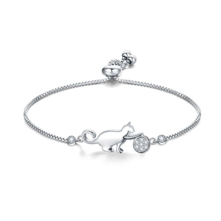 Close-up of elegant women's cat charm bracelet. Silver-tone with sparkling cubic zirconia, a chic accessory.