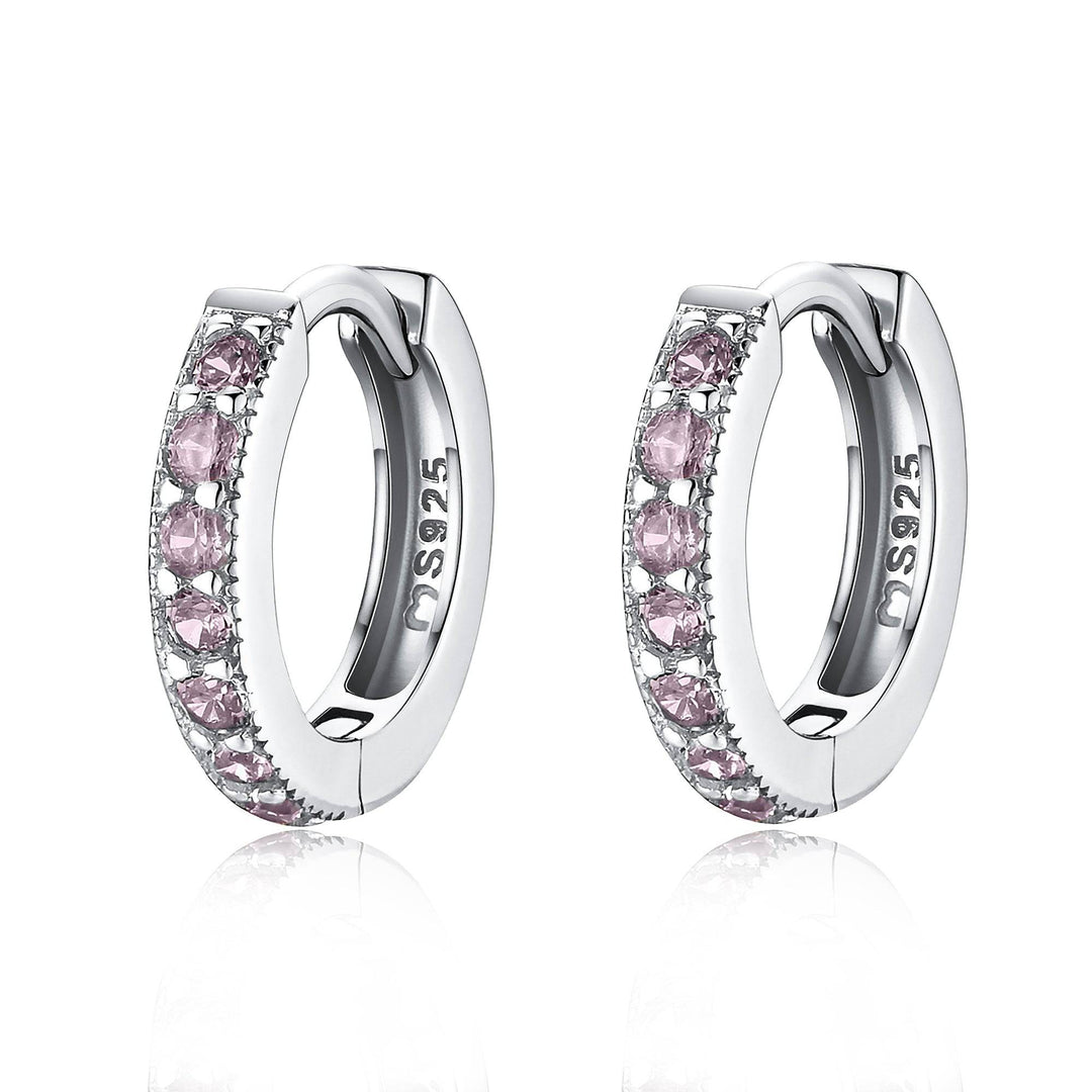 Close-up of dazzling zirconia hoop earrings, available in gold-plated finish. Elegant women's jewelry.