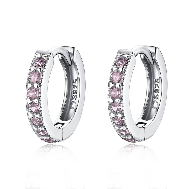 Close-up of dazzling zirconia hoop earrings, available in gold-plated finish. Elegant women's jewelry.