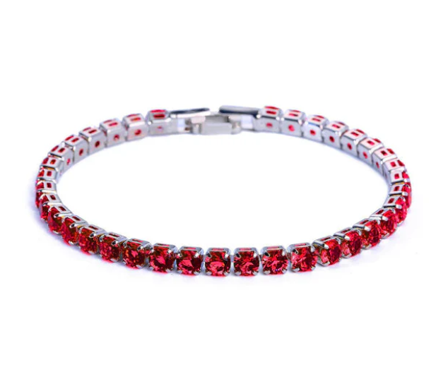 Close-up of a women's delicate zirconia tennis bracelet, shimmering stones & adjustable fit. Elegant jewelry.