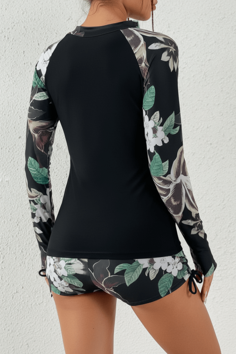 Stylish tropical print rashguard beachwear two-piece swimsuit for women, perfect for sunny vacations.