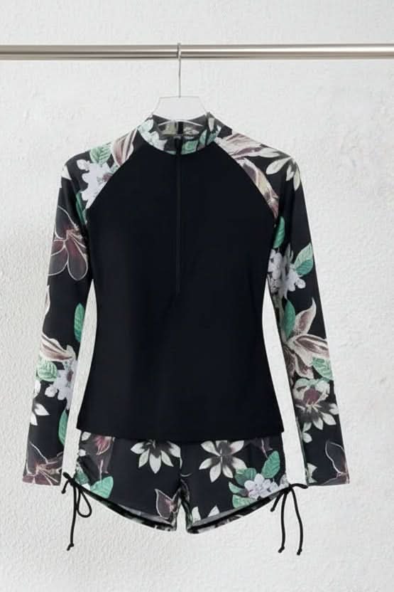 Women's vacation outfit: two-piece tropical rashguard swimsuit, perfect for sun-protected active wear.